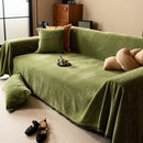 Minimalist chenille sofa towel in Herribone style with fringed border.