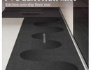 Black, long kitchen mat made of waterproof PVC.