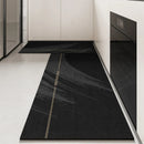 Black, long kitchen mat made of waterproof PVC.