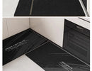 Black, long kitchen mat made of waterproof PVC.