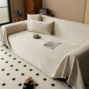 Minimalist chenille sofa towel in Herribone style with fringed border.