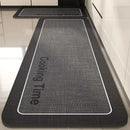 Black, long kitchen mat made of waterproof PVC.
