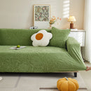 Elastic sofa cover with camellia jacquard print.