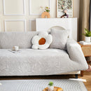 Elastic sofa cover with camellia jacquard print.