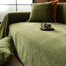 Minimalist chenille sofa towel in Herribone style with fringed border.