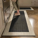 Black, long kitchen mat made of waterproof PVC.