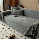 Minimalist chenille sofa towel in Herribone style with fringed border.