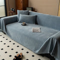 Minimalist chenille sofa towel in Herribone style with fringed border.