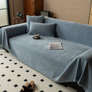 Minimalist chenille sofa towel in Herribone style with fringed border.