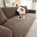 Elastic sofa cover with camellia jacquard print.